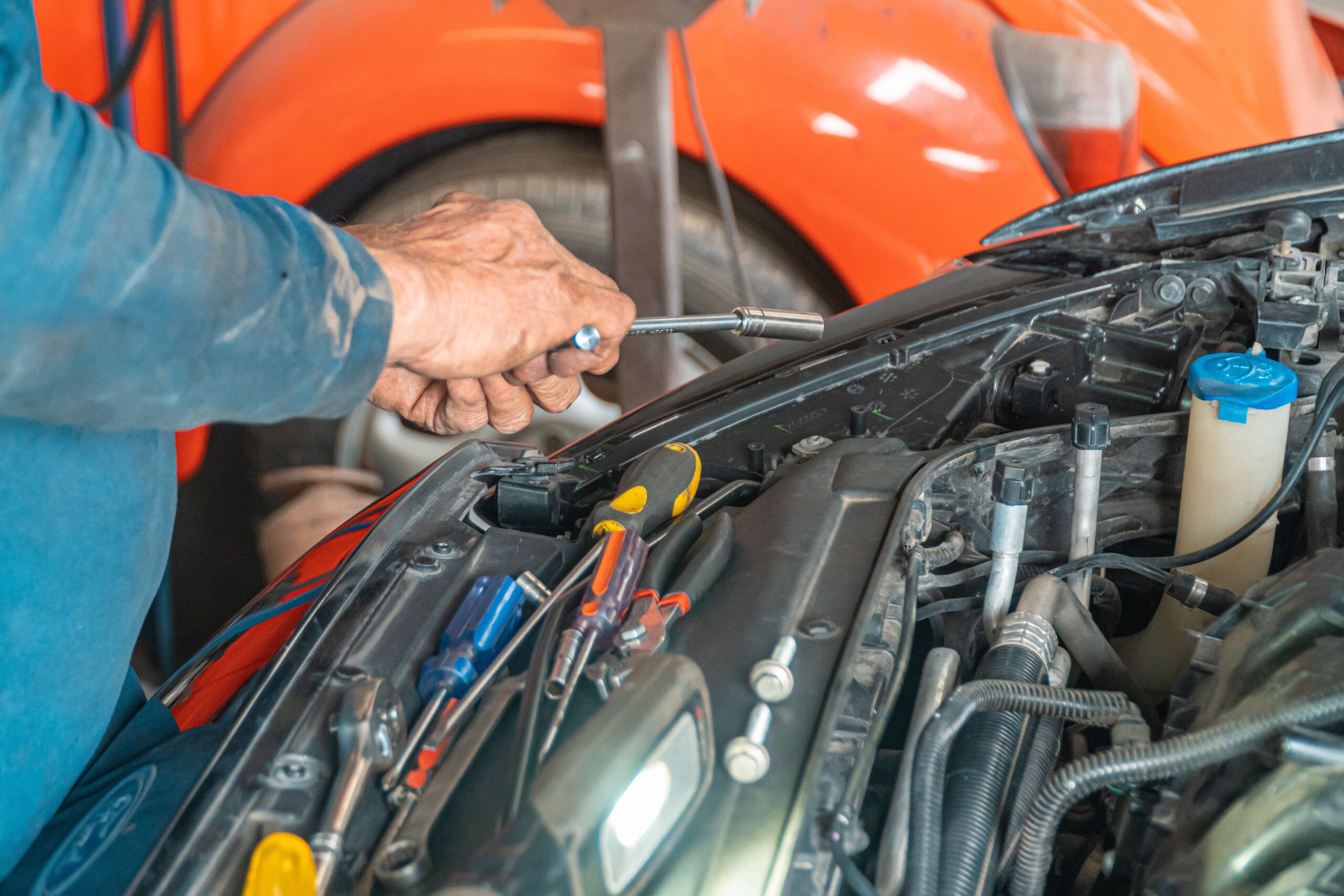 Mechanic working on car in garage